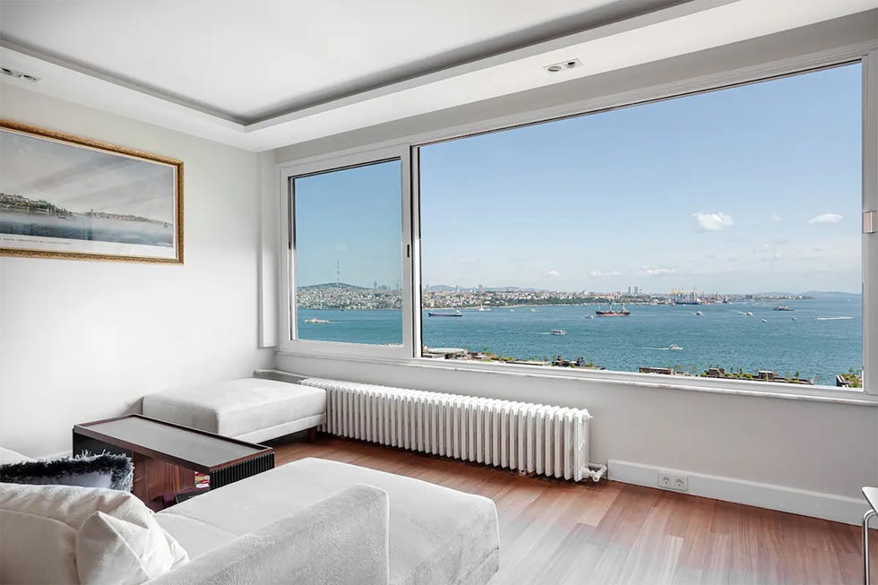 modern living room with a view of a body of water and city skyline