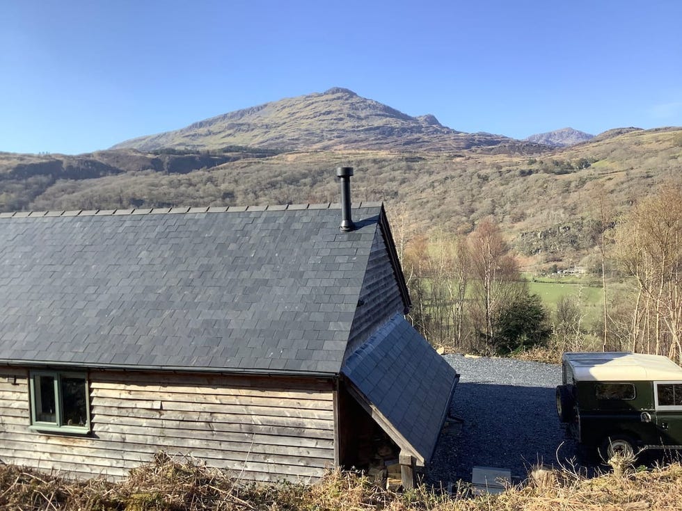 a house with a mountain in the background