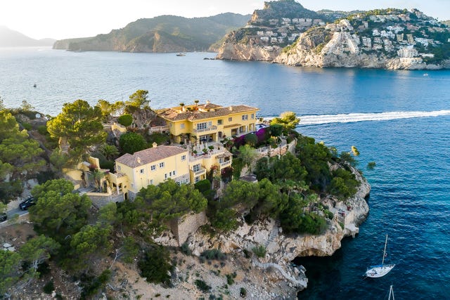 a building on a hill by the water