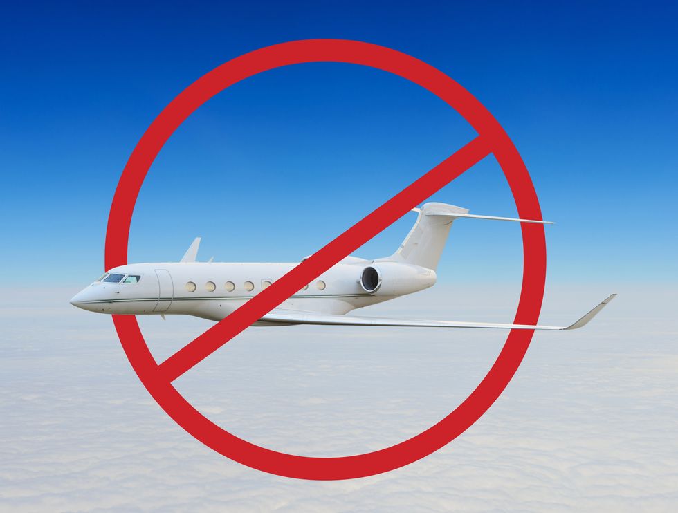 airplane in sky in red round ban sign
