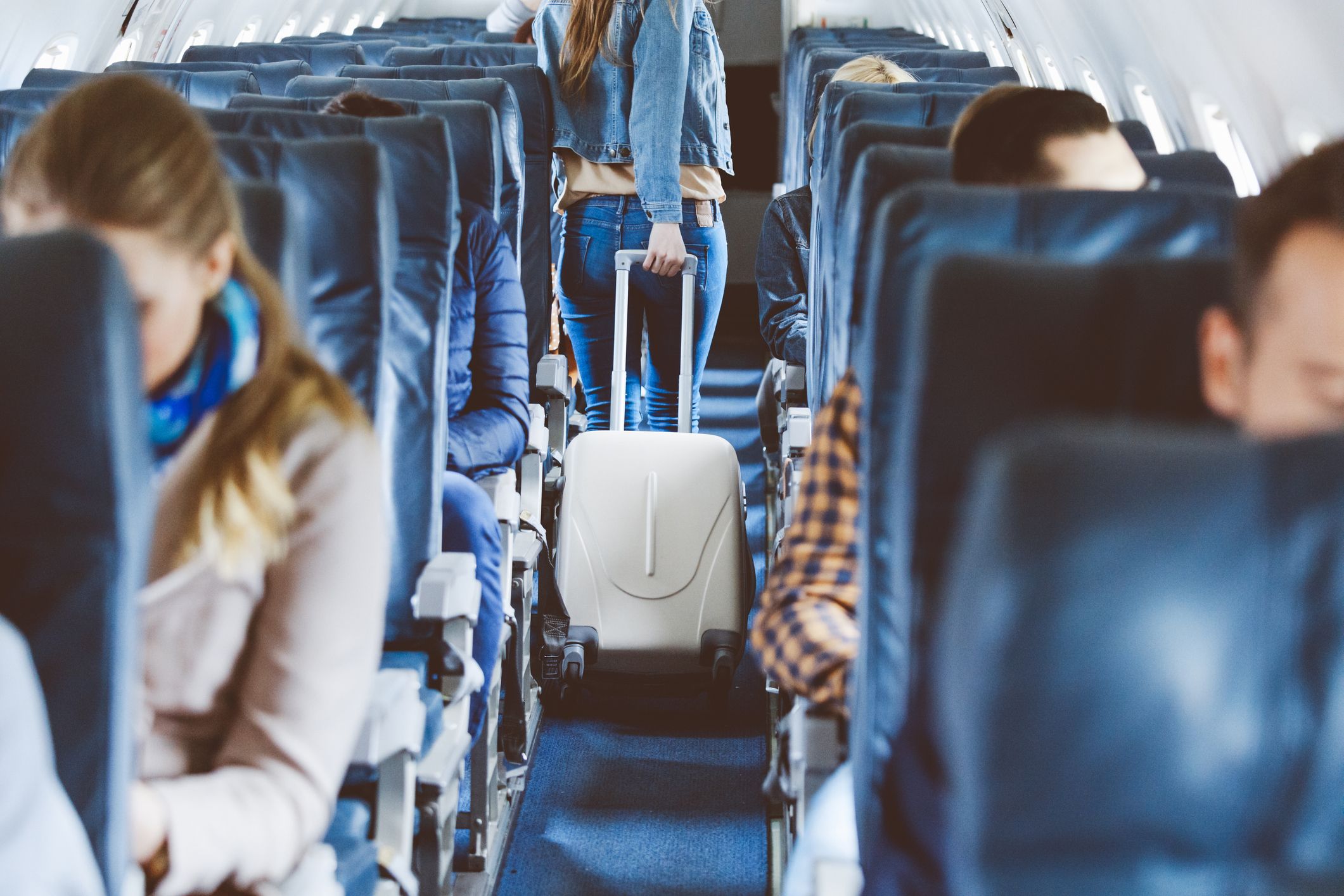 https://hips.hearstapps.com/hmg-prod/images/airplane-interior-with-people-sitting-on-seats-royalty-free-image-1698769747.jpg