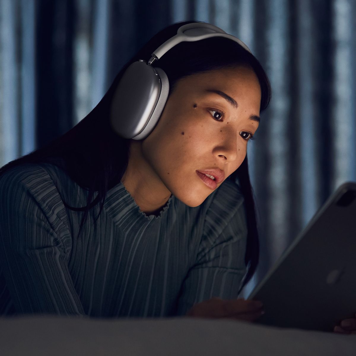 woman wearing apple airpods max wireless noise canceling headphones