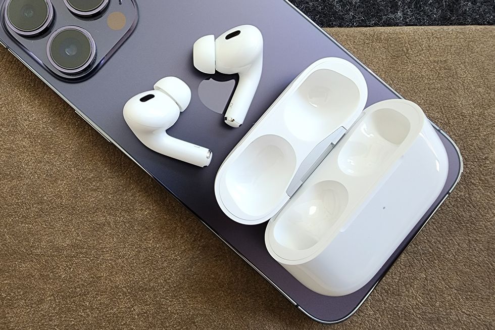 airpods pro second generation and charging case on iphone 14