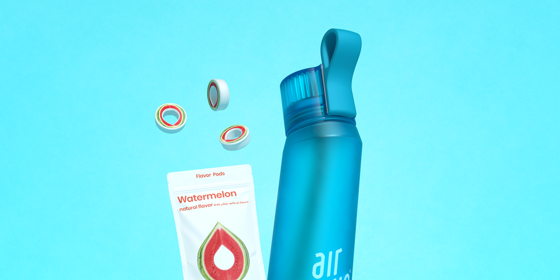 air up water bottle in blue with water melon pods on a teal background