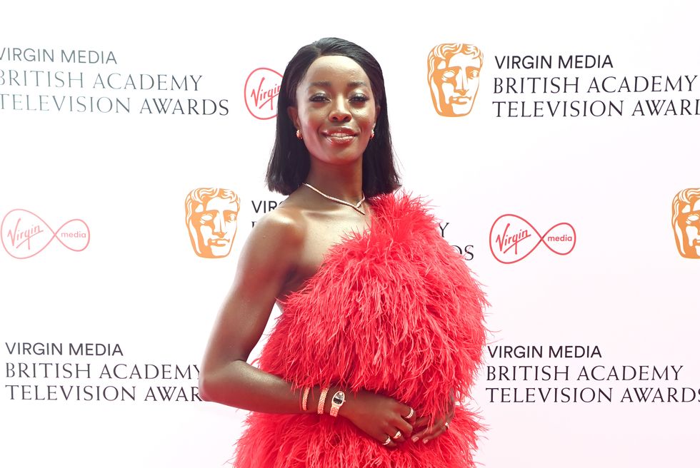 aj odudu wearing red feathering dress at the virgin media british academy television awards 2021
