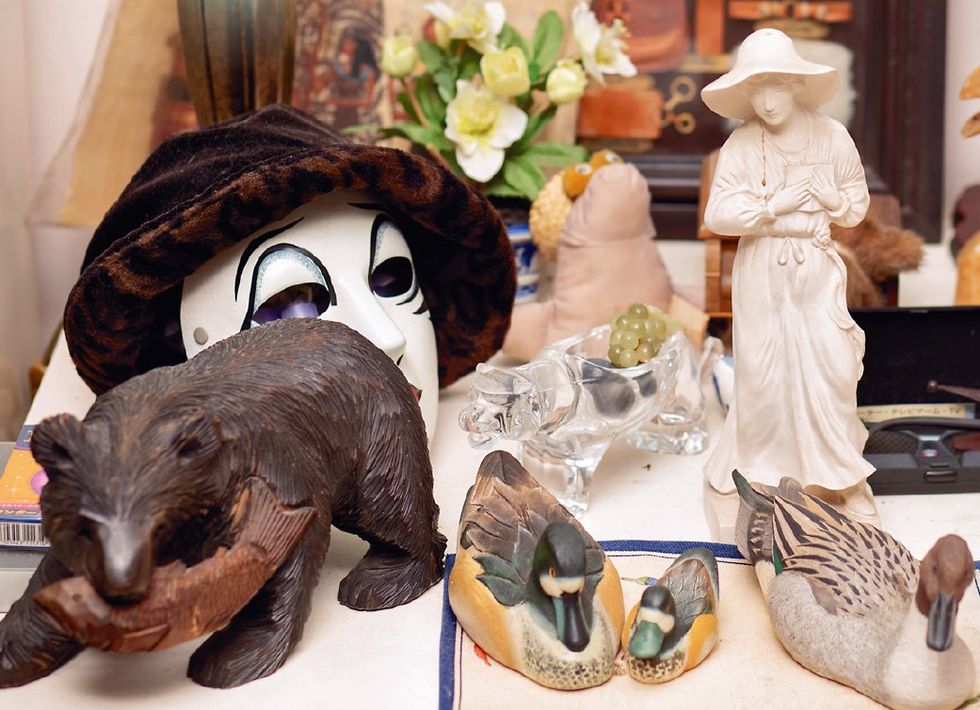 a table with a variety of figurines and a bear