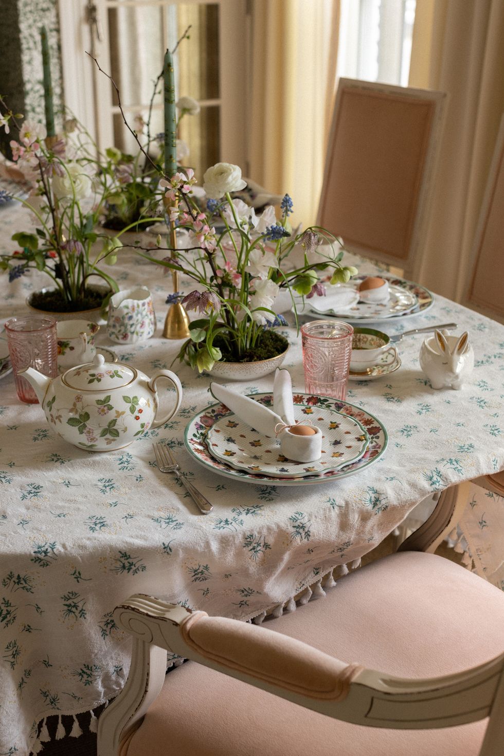 a table with a tea set and teacups
