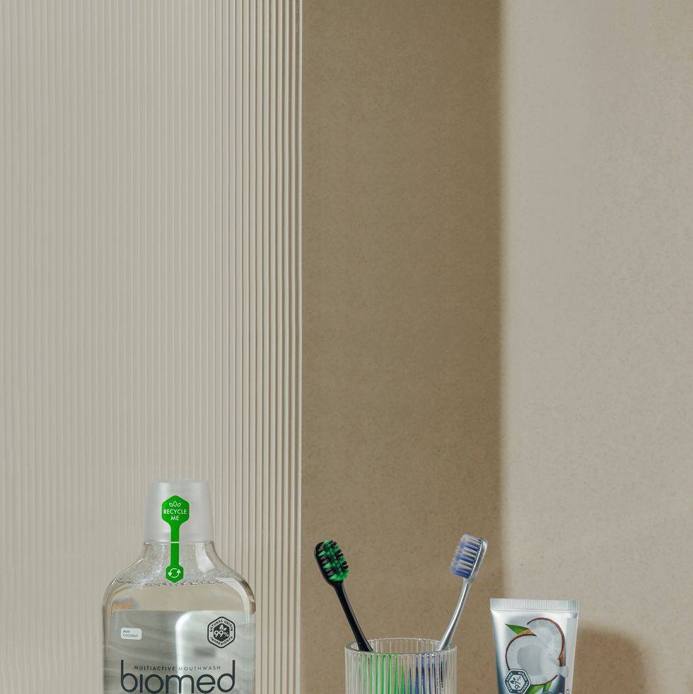 a bottle of toothbrushes and a couple of toothbrushes