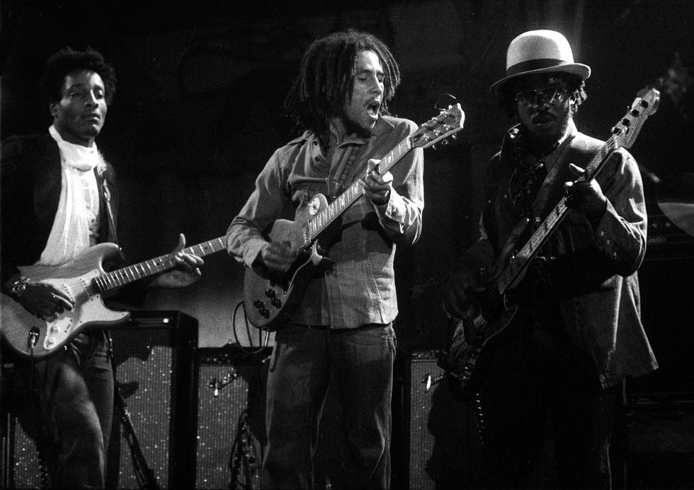 bob marley and the wailers playing music at a concert