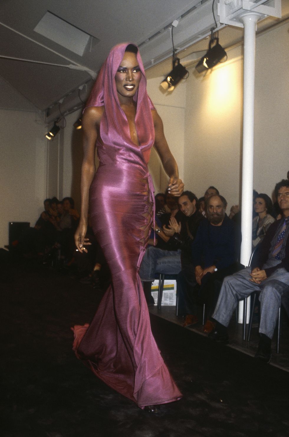 tunisian designer azzedline alaia shows his women's 1986 spring summer haute couture line in paris model grace jones, also known for her singing and acting career, is wearing a clingy pink dress with an attached hood photo by pierre vautheysygmasygma via getty images