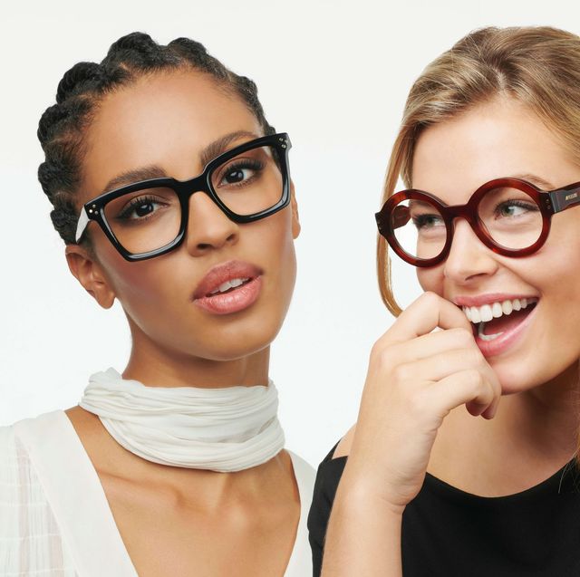 a couple of women wearing glasses and smiling at the camera