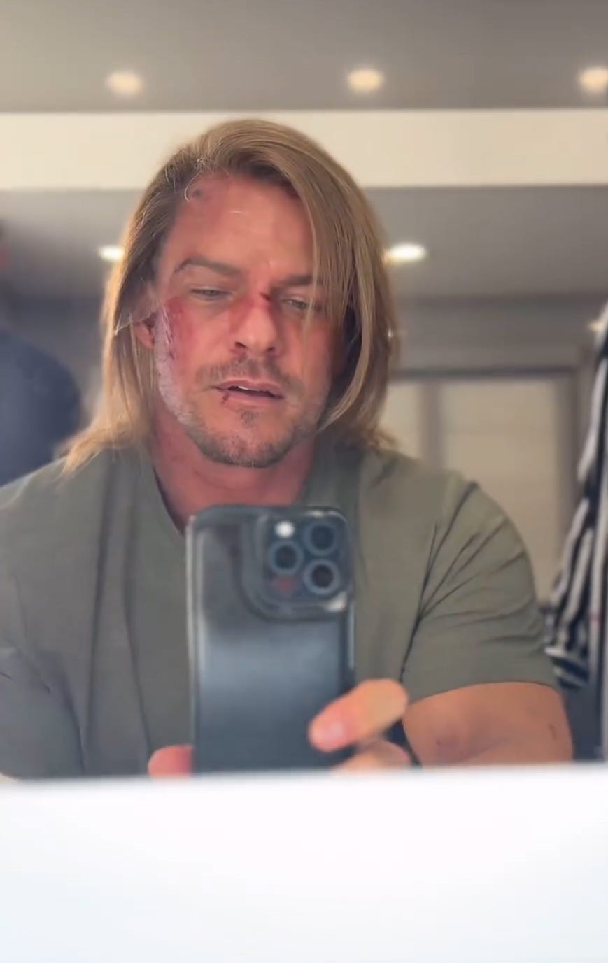 Alan Ritchson seen with long hair takes a selfie in front of the mirror