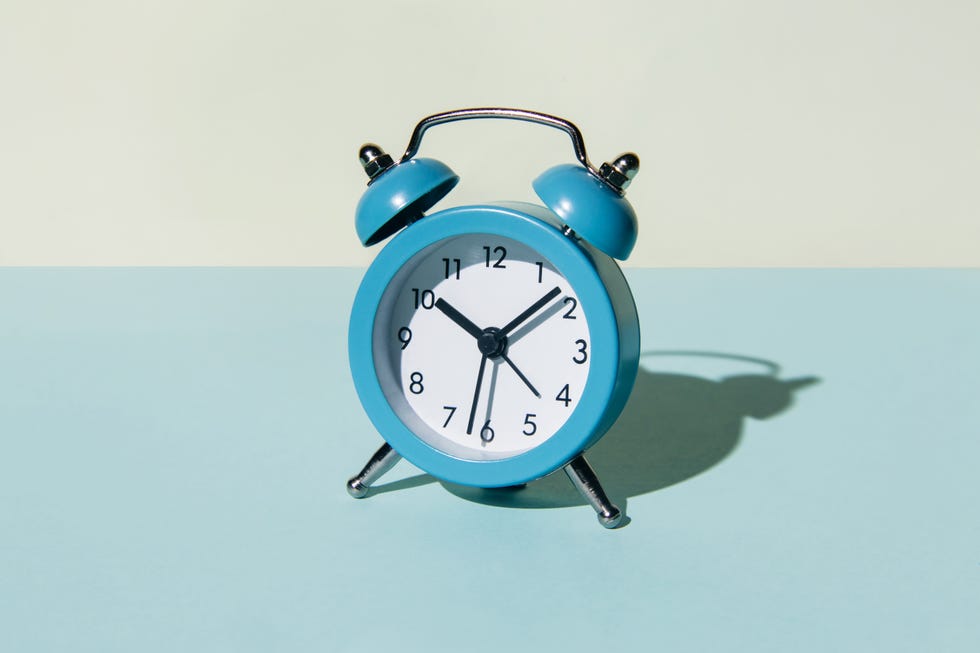 alarm clock on a blue and beige background