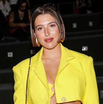 fashionable individual in bright yellow attire at an event fashionable individual in bright yellow attire at an event