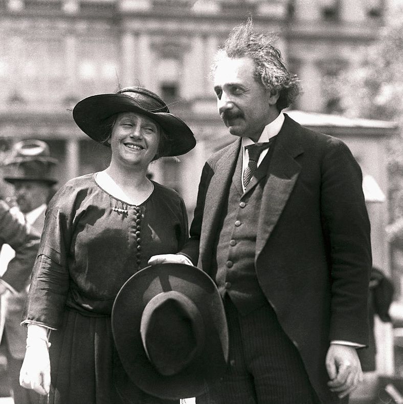 albert einstein holding his hat next to his wife elsa