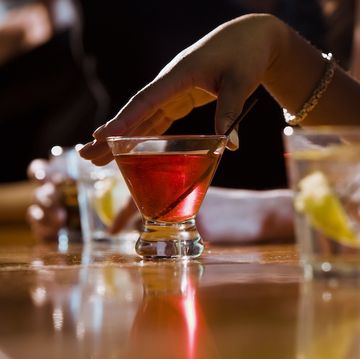 woman drinking a cocktail in a bar