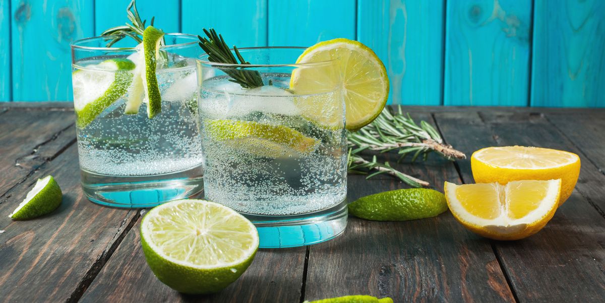 Alcoholic drink gin tonic cocktail with lemon, rosemary and ice