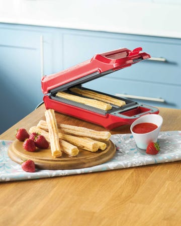 aldi churro maker with churros and a strawberry sauce
