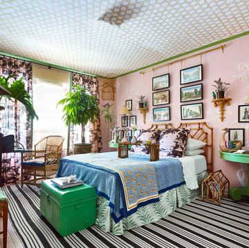 Pink and green bedroom with cane detailing on ceiling