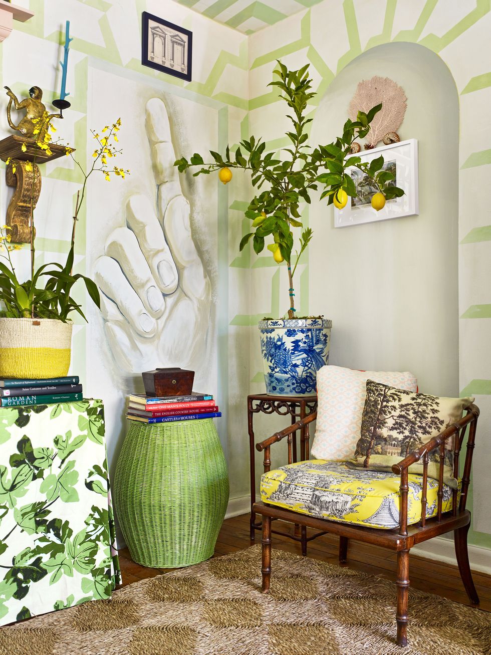 green, yellow, and blue room with muraled hand on wall