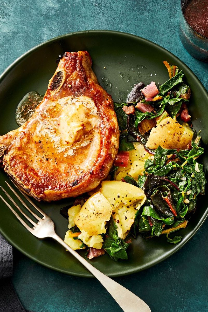 aleppo pork chops with potatoes and greens on a green plate