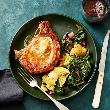 aleppo pork chops with potatoes and greens on a green plate