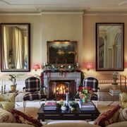 the fabric on the chairs is an authentic scottish wool plaid and there is a fire blazing in the fireplace