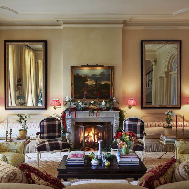 the fabric on the chairs is an authentic scottish wool plaid and there is a fire blazing in the fireplace