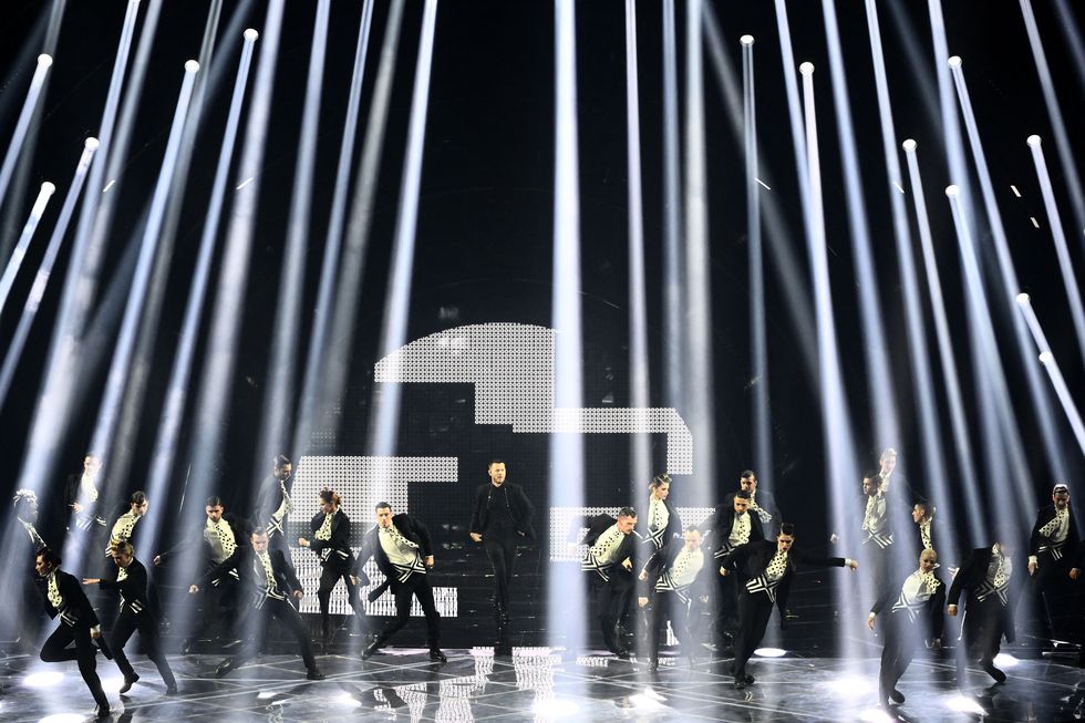 italian television presenter alessandro cattelan c and dancers perform at the start of the second semifinal of the eurovision song contest 2022 on may 12, 2022 at the pala alpitour venue in turin photo by marco bertorello  afp photo by marco bertorelloafp via getty images