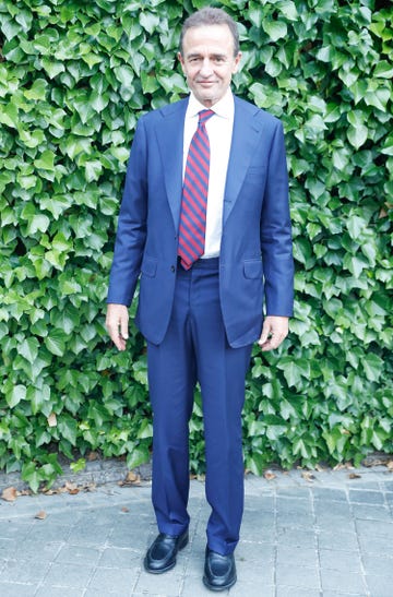el italiano con un traje color azul, camisa blanca y corbata de rayas