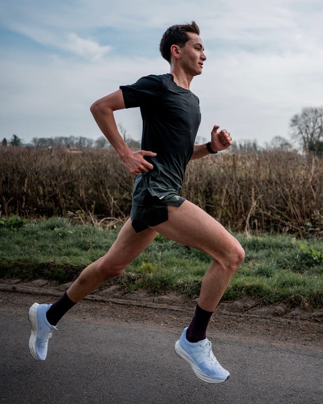 alex yee running fast and determined along a country road