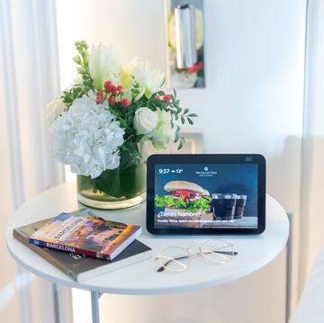 a tablet and flowers on a table