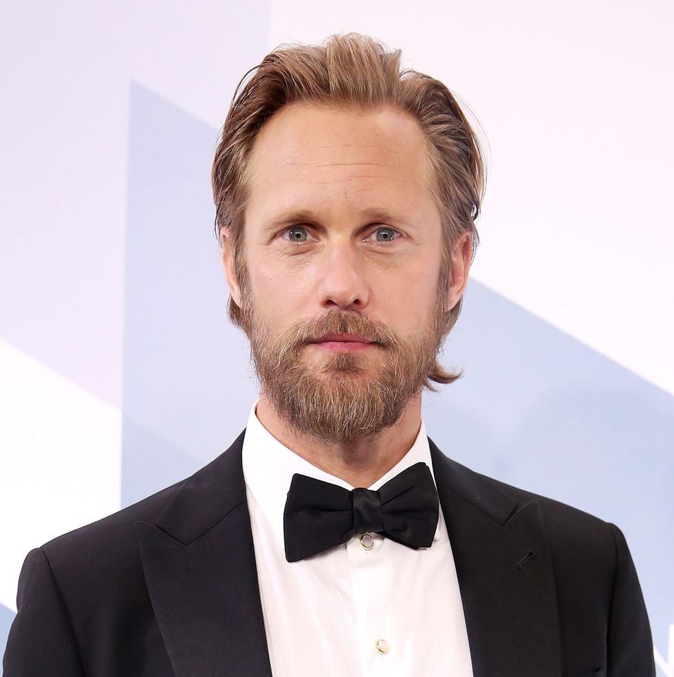 alexander skarsgård with beard and wearing black tuxedo and bow tie