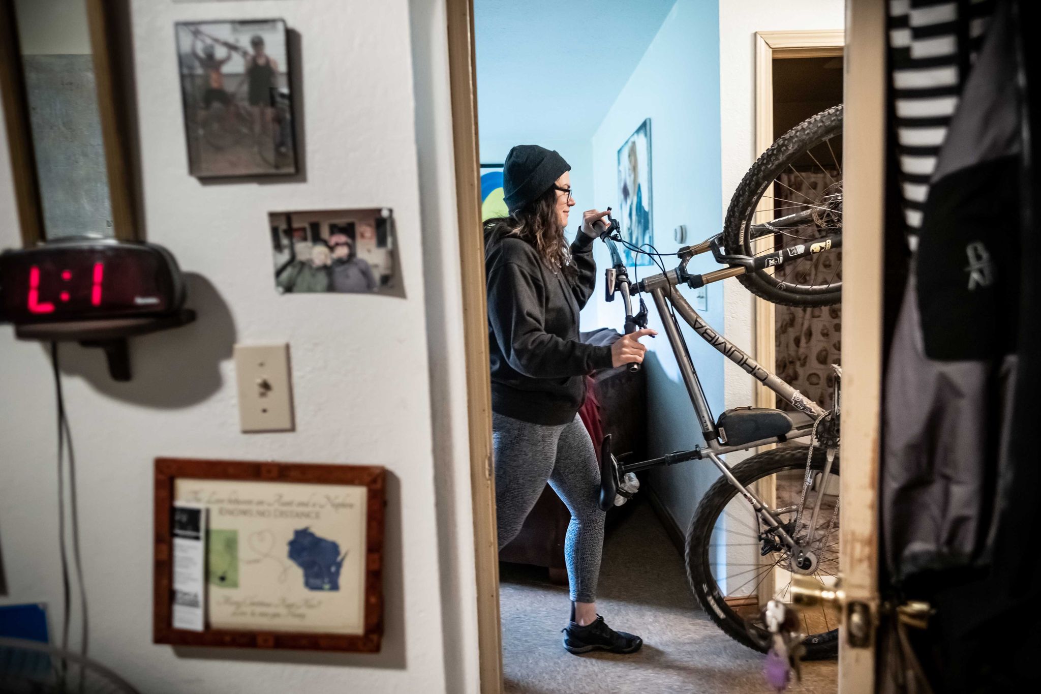 Alexandera Houchin wheels her bike out of her room in preparation for a ride in Cloquet, MN on October 22, 2019.