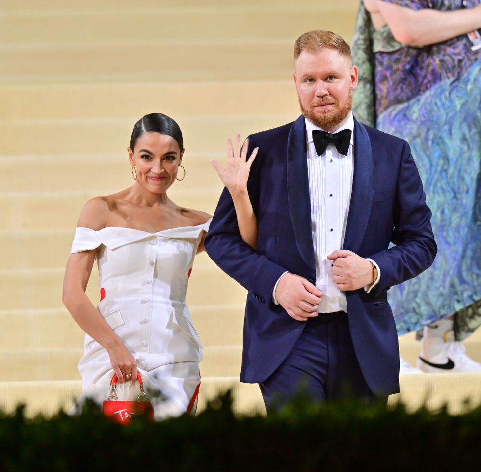 representative alexandria ocasio cortez posing with her fiance riley roberts at the 2021 met gala celebrating in america a lexicon of fashion