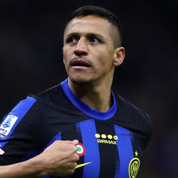 alexis sanchez runs on a football pitch as he plays for inter milan