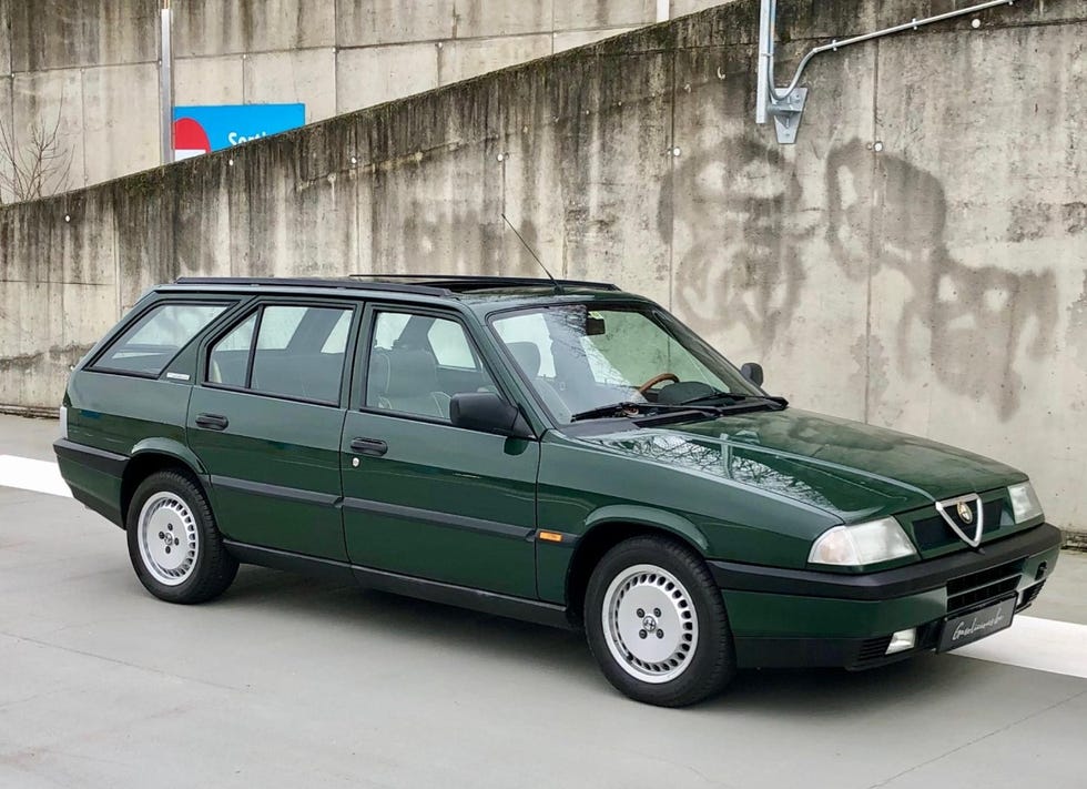 a green car parked on the side of a road