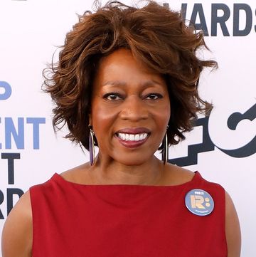 alfre woodard smiles on the red carpet at the 2020 film independent spirit awards in february 2020, wearing a red dress