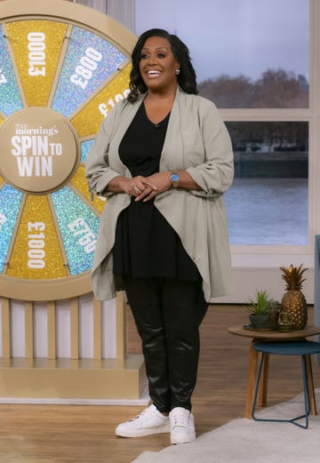 alison hammond on the set of this morning wearing black trousers and a top with a sage waterfall duster jacket