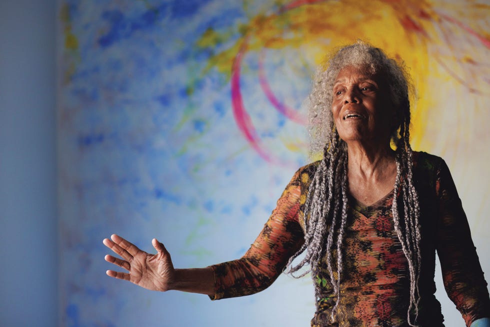 author and multidisciplinary artist alison mills newman is photographed in front of a wall she is painting in the kitchen of her home in atlanta ga