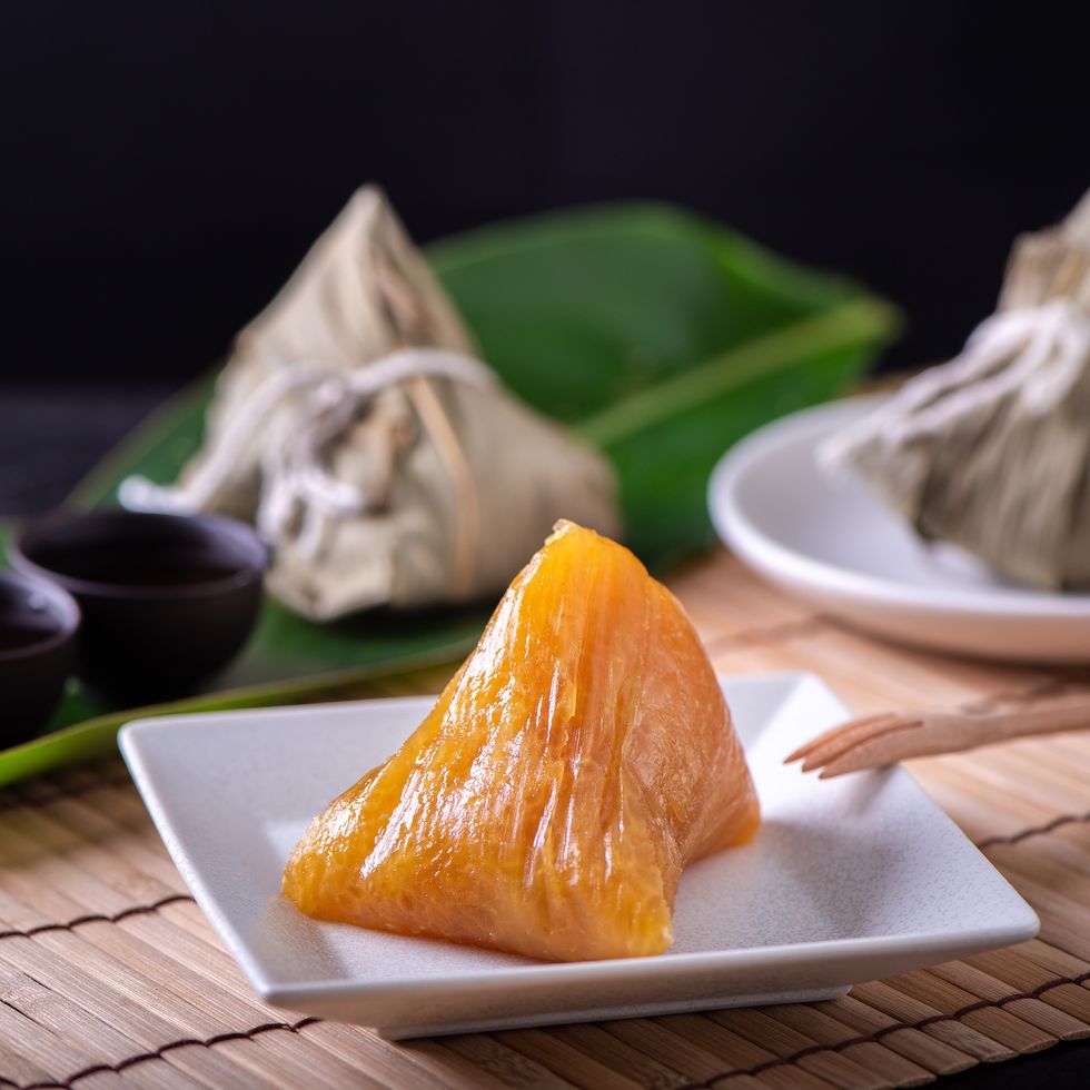 alkaline rice dumpling zongzi traditional sweet chinese crystal food on a plate to eat for dragon boat duanwu festival celebration concept, close up