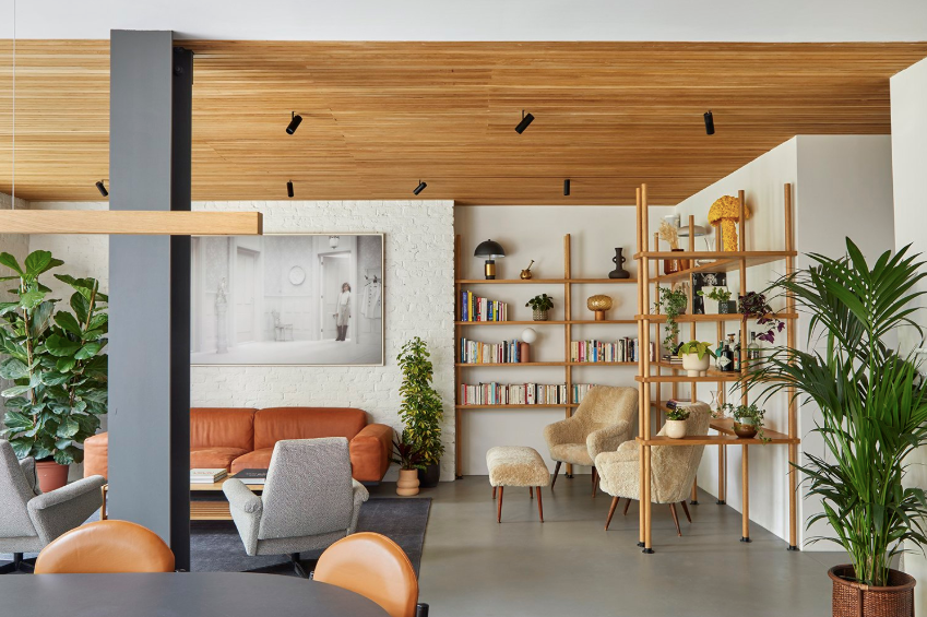 living space featuring seating plants and bookshelves living space featuring seating plants and bookshelves