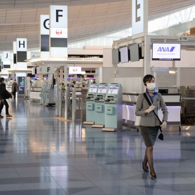 all nippon airways ana employee walks through the check in