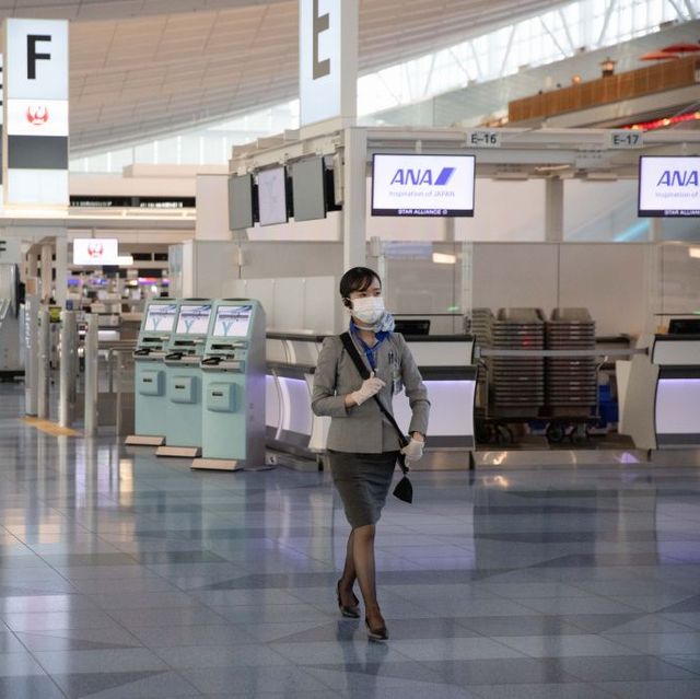 all nippon airways ana employee walks through the check in