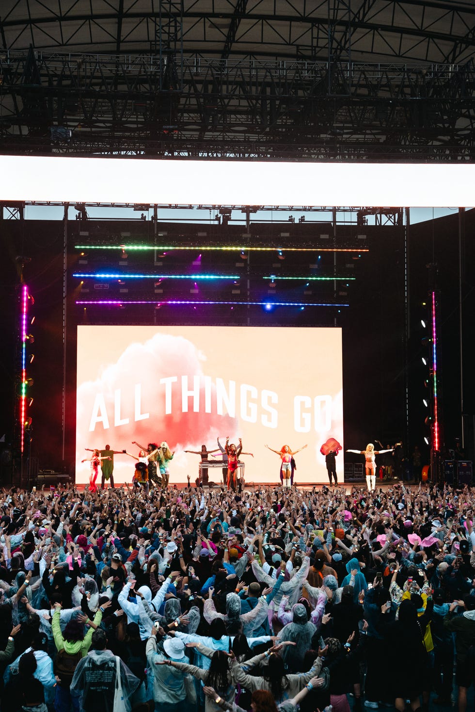 drag performers lead the all things go crowd through the “hot to go” dance