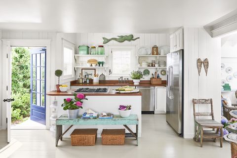 a white beach house kitchen with pops of color