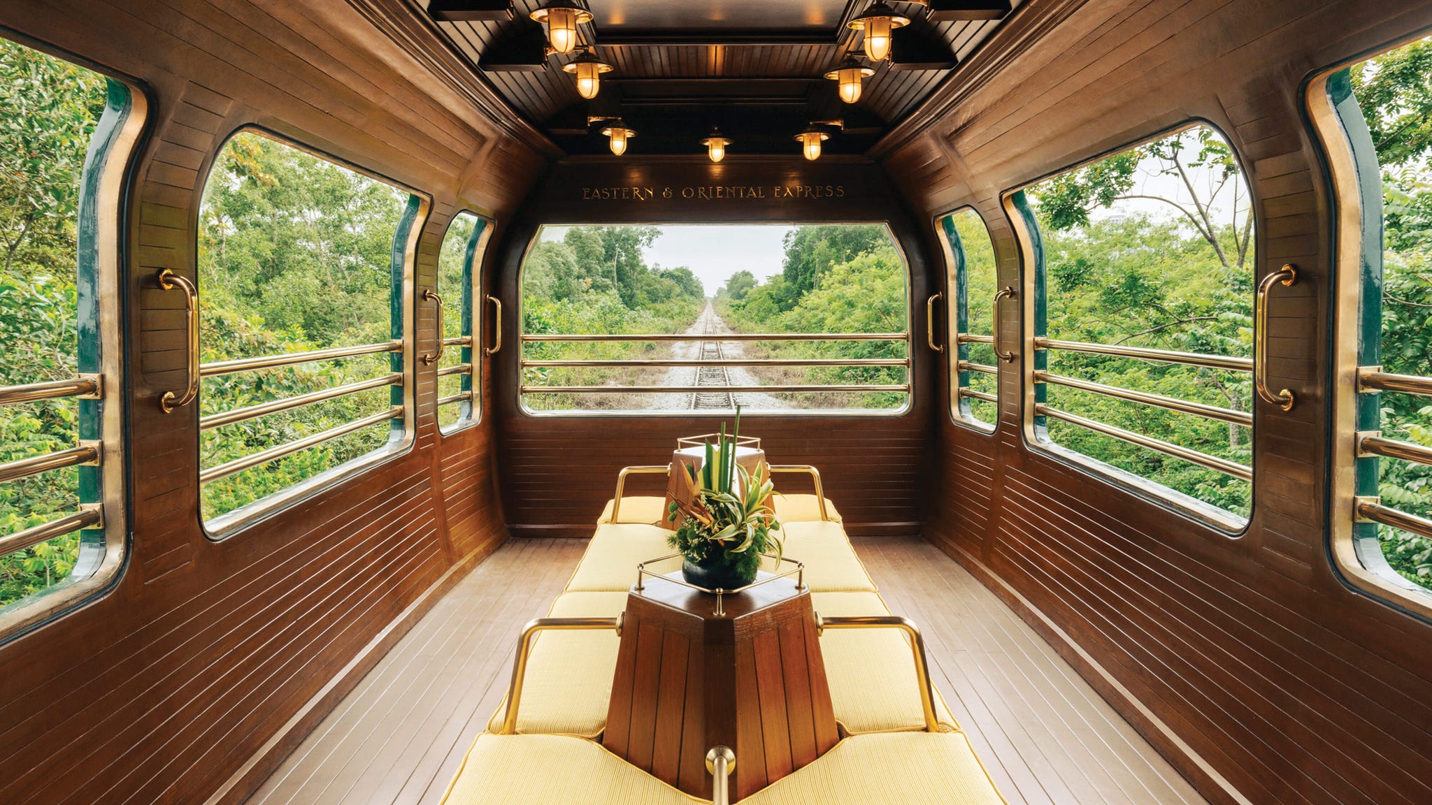 luxury train lounge with yellow seating and large windows