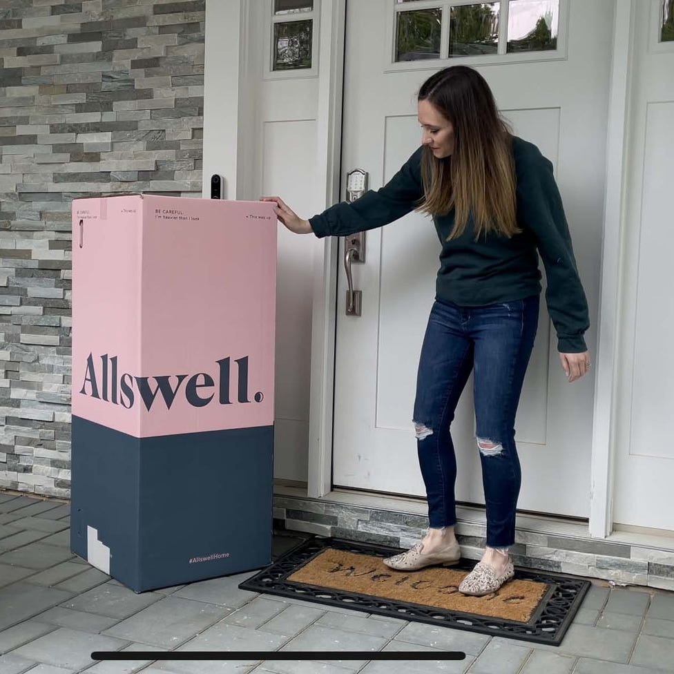 best cheap mattress - mattress delivery someone standing next to an allswell mattress box on their front porch
