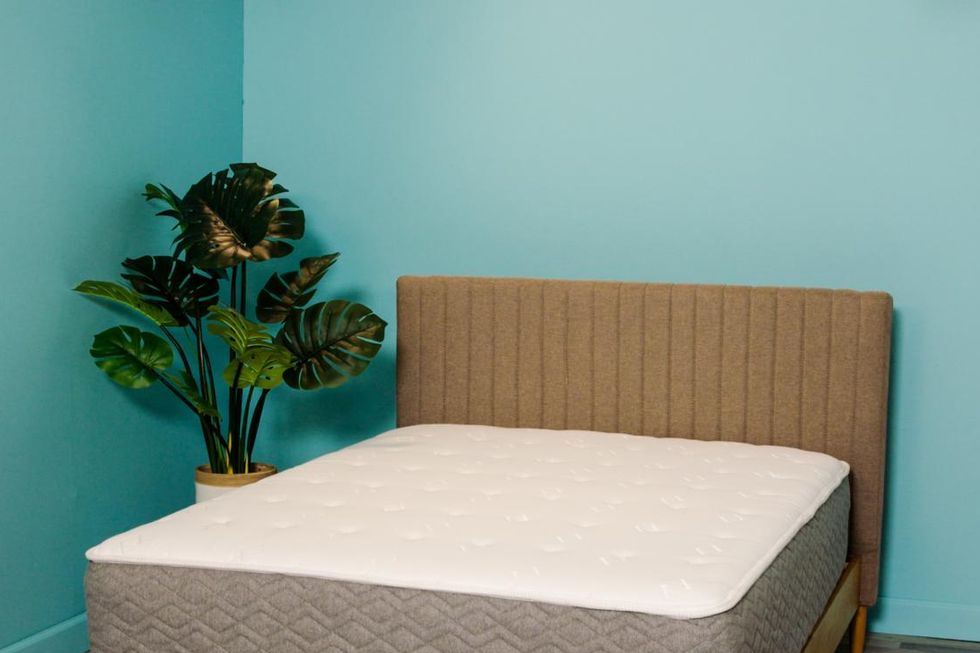 allswell luxe hybrid mattress on a bed frame at good housekeeping