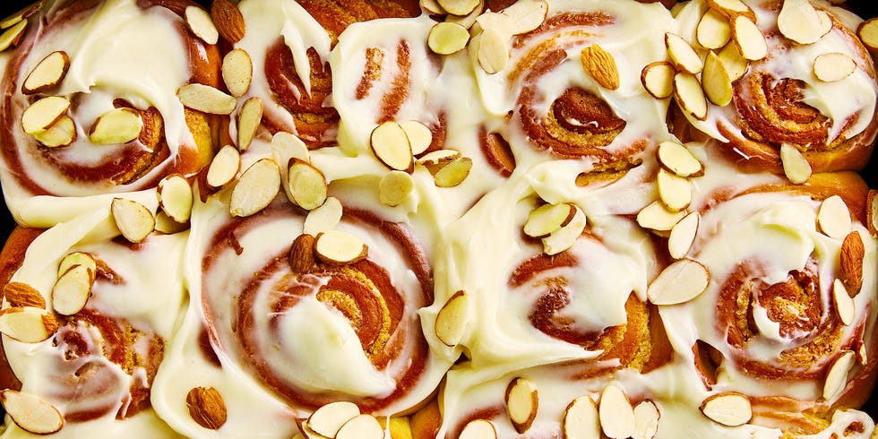 cinnamon rolls with cream cheese icing and sliced almonds